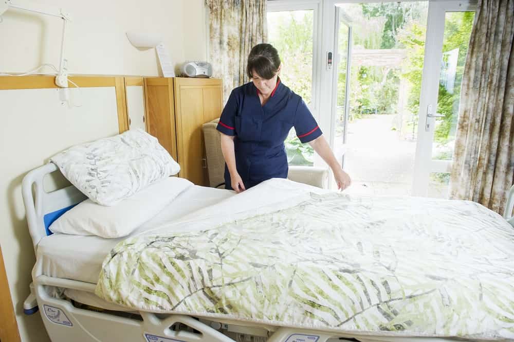 Nurse in adult in-patient bedroom