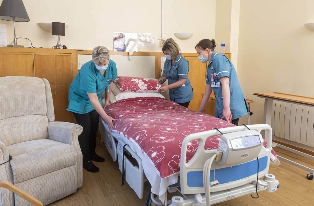 Nurses in hospice in-patient room