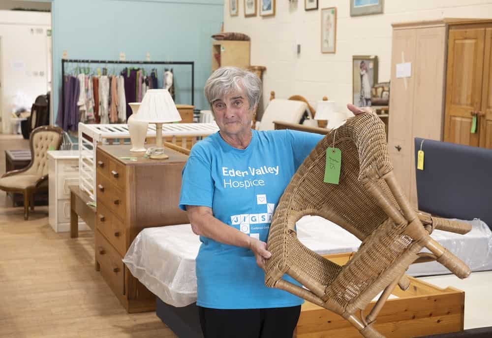 Volunteer holding an item in furniture shop