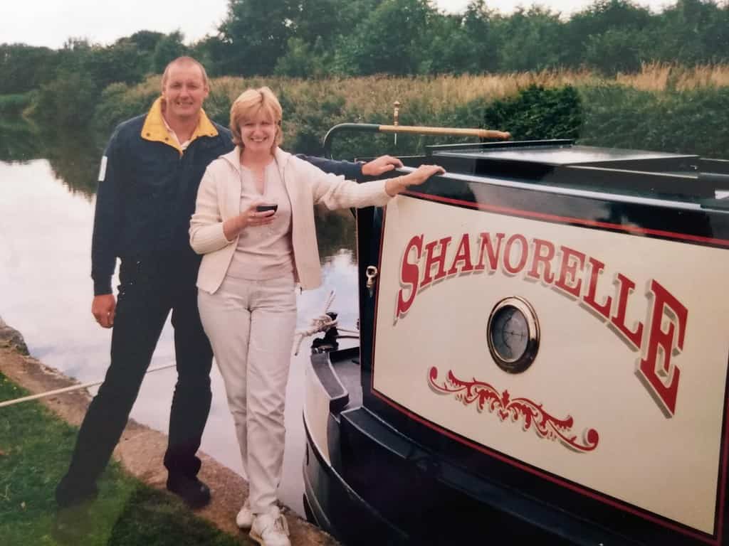 Graham and Val pictured next to a canal boat.