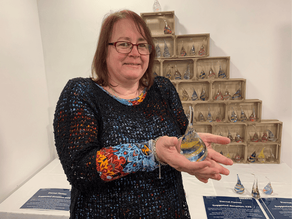 Women holding eternal flames for sale.