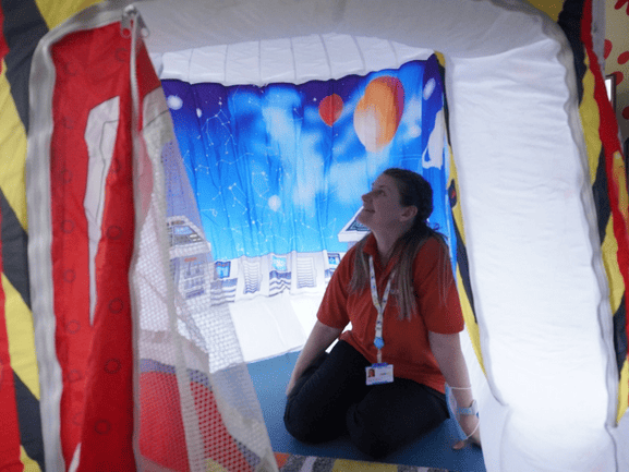 Nurse inside children's immersive tent.