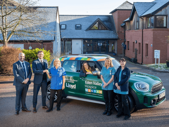 Nurses pictured with a new MINI presented by MINI staff.
