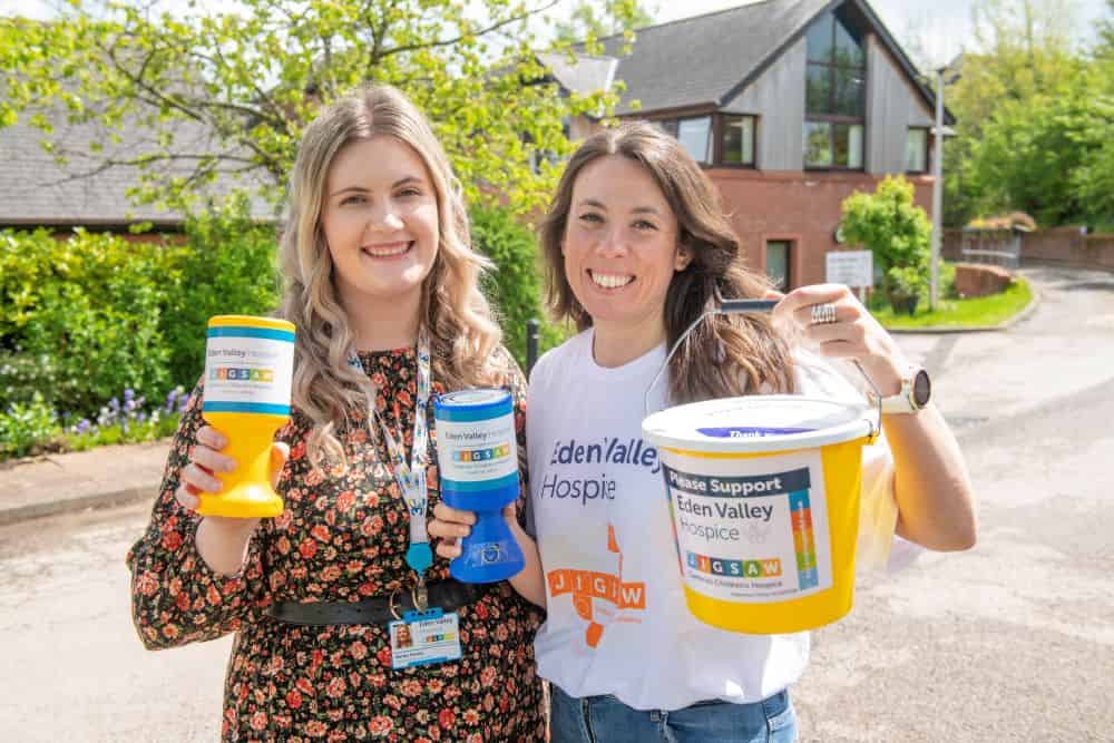 Fundraisers Martha and Eleanor holding up collection boxes