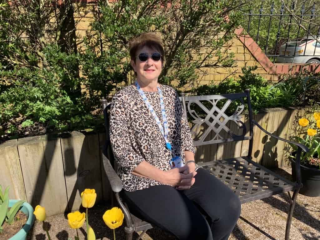 Gardening volunteer Cynthia sat in the walled garden at Eden Valley Hospice.