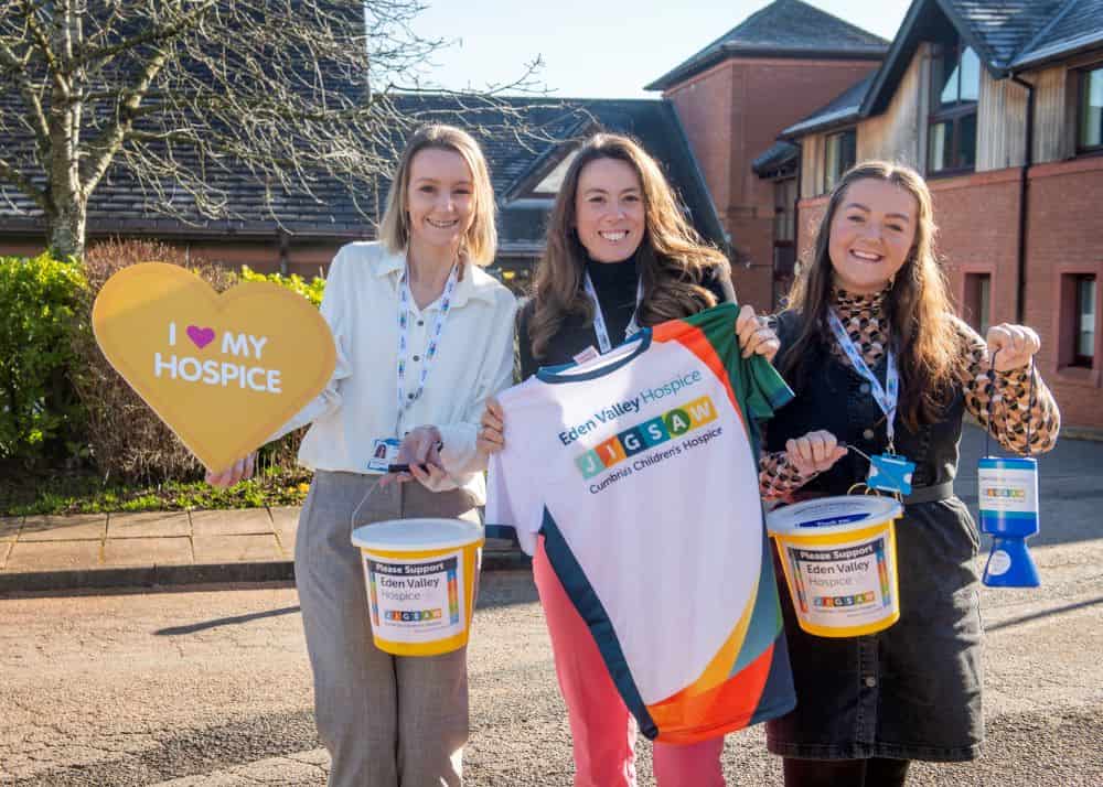 Fundraisers holding up home money boxes.