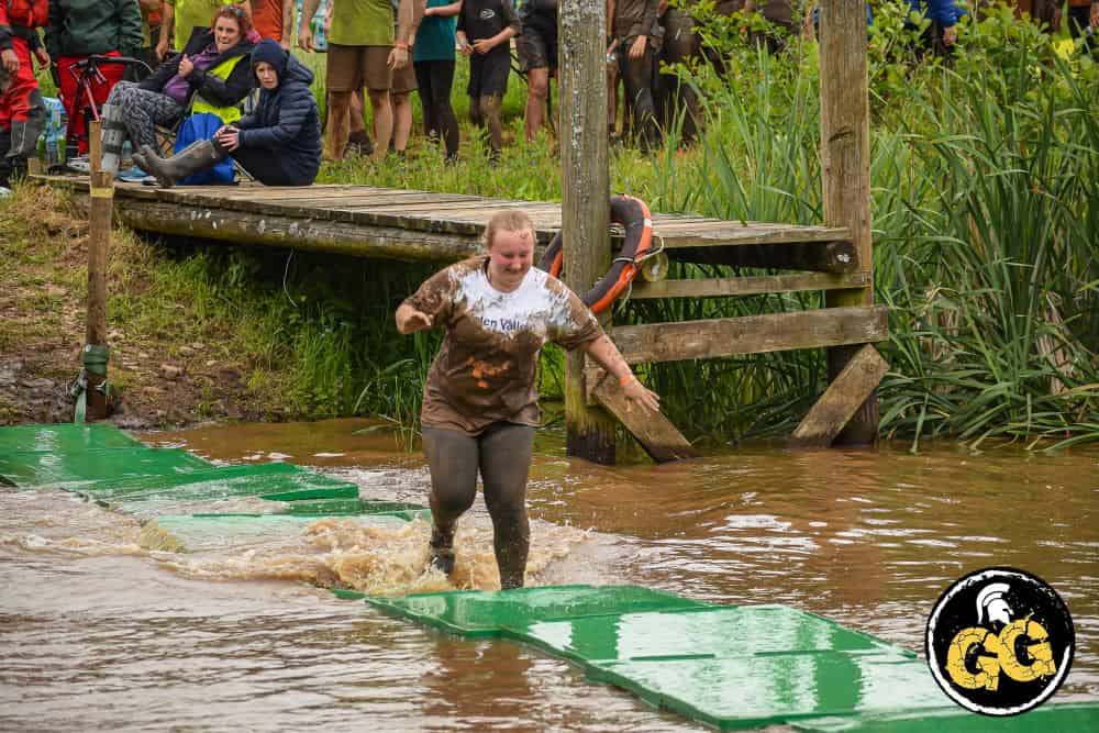 Competitor running over water at fundraising event Gelt Gladiator