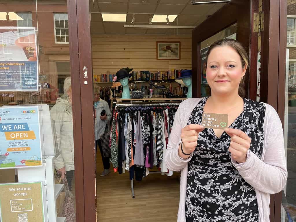 Shop manager Beth Weir holding the Charity Shop Gift Card