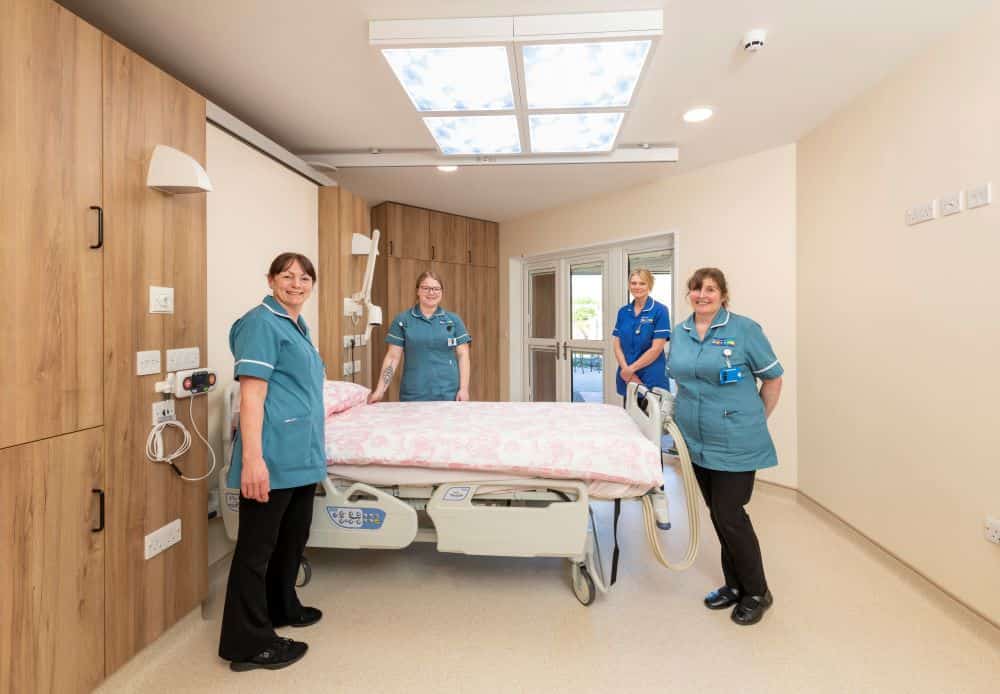 Nurses pictured in hospice bedroom