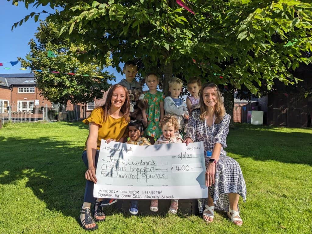 Hospice representative Vicki Lesley with staff and children from Stone Eden Nursery