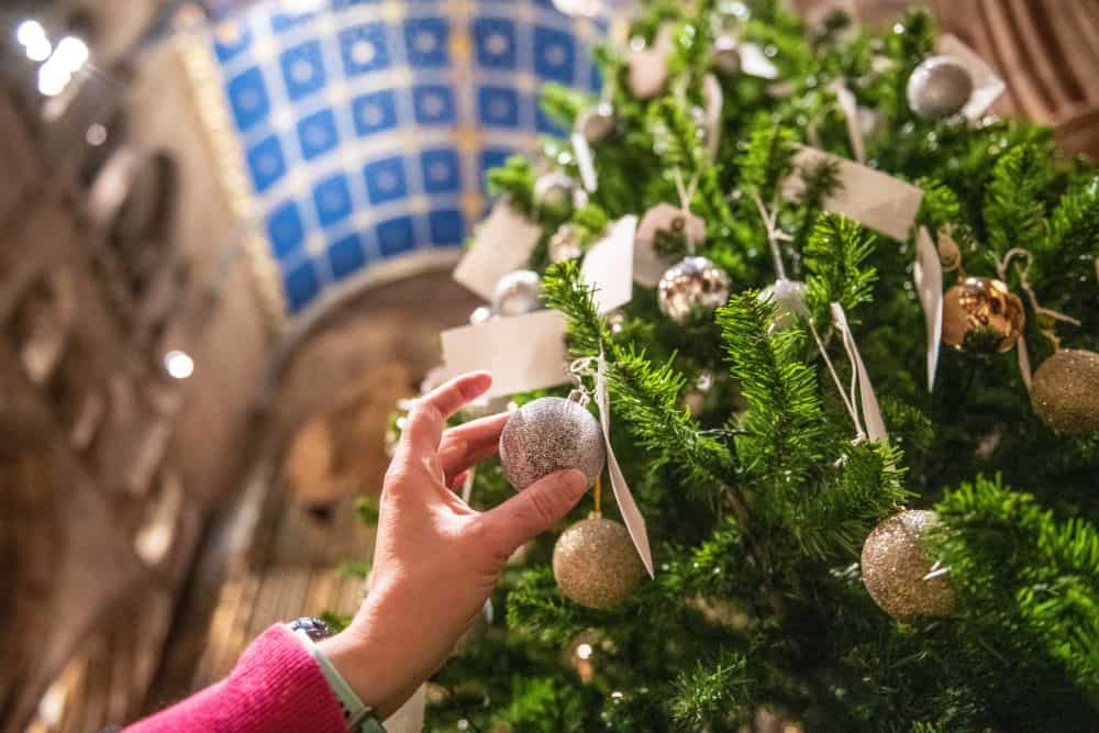 Putting baubles on the Light up a Life tree