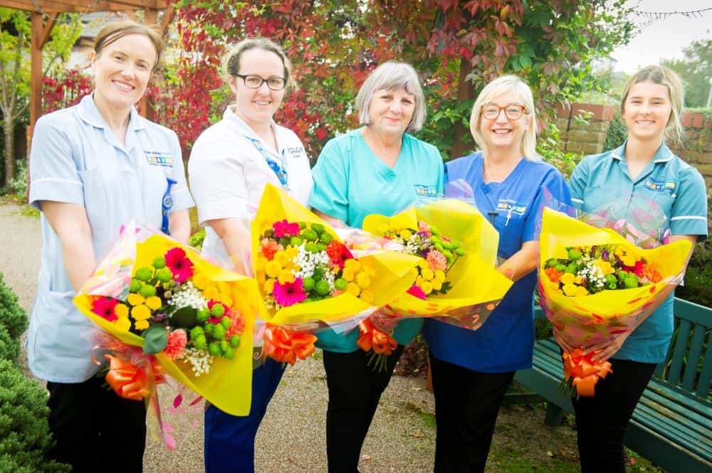 Nurses holding flowers