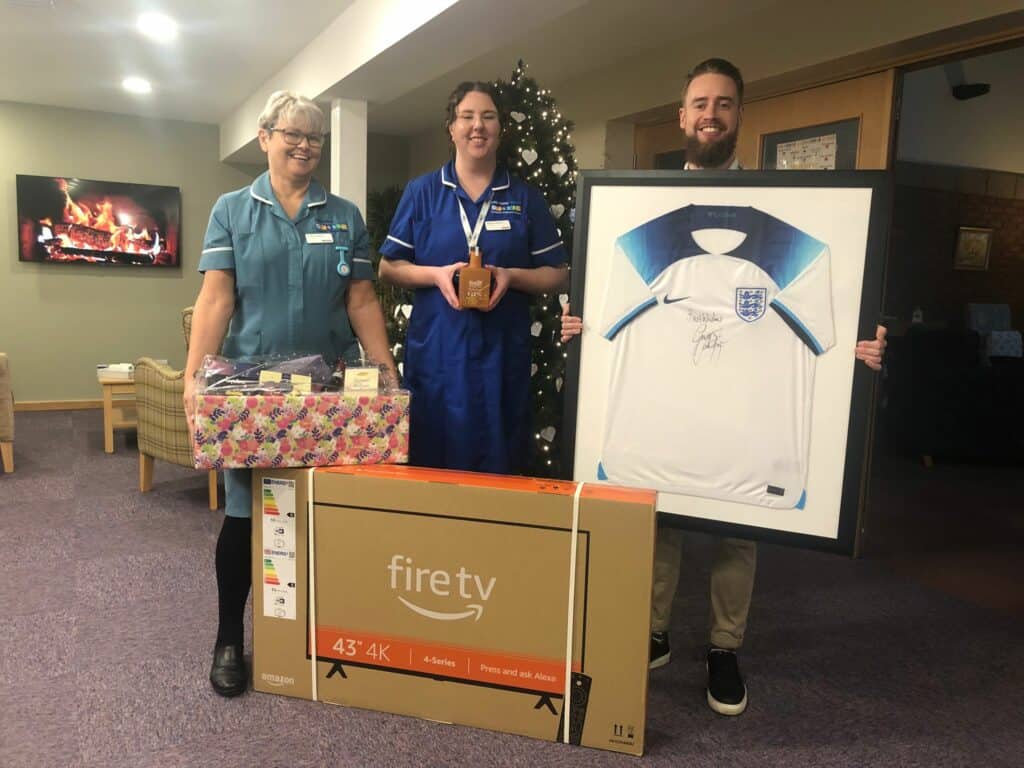 Nurses holding items from the auction