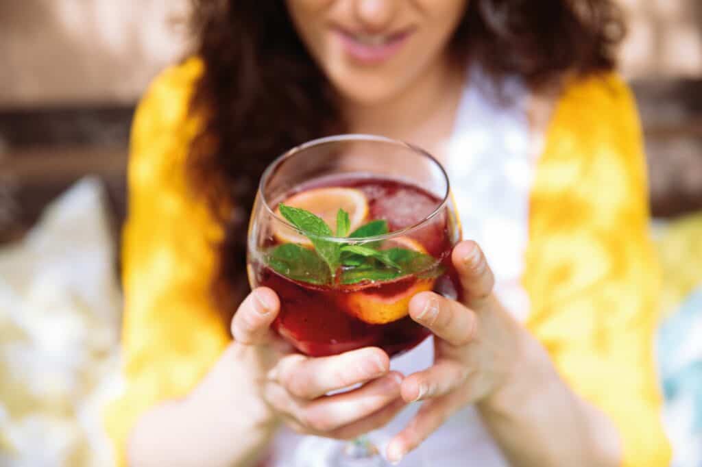 Woman holding a drink.
